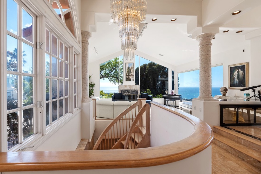 Custom curved wood stairs leading downstairs to bedrooms 3 and 4