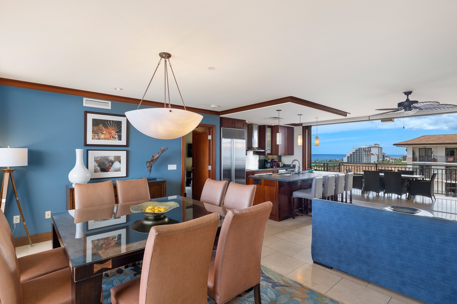 Relax in your stylish open-plan living space with stunning ocean views through floor-to-ceiling windows and elegant modern furnishings.