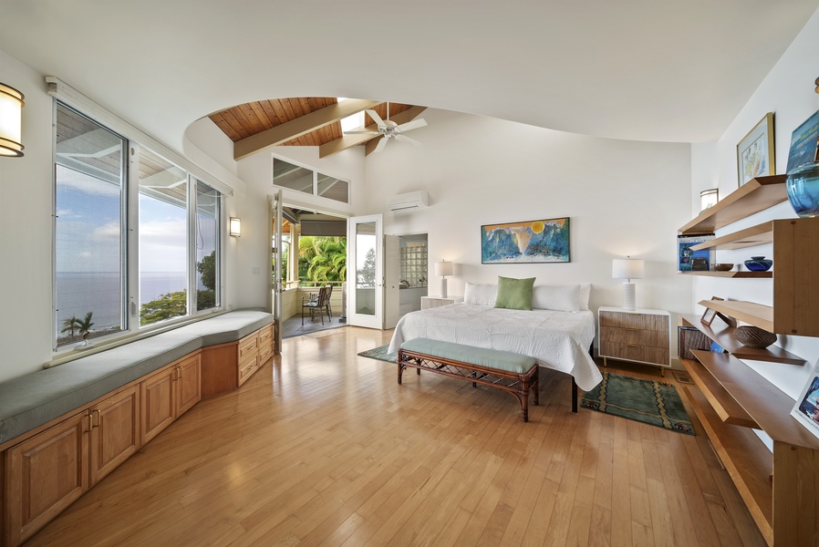 Savor the stunning ocean views in this elegant bedroom and soaring wood-beam ceilings and direct patio access.