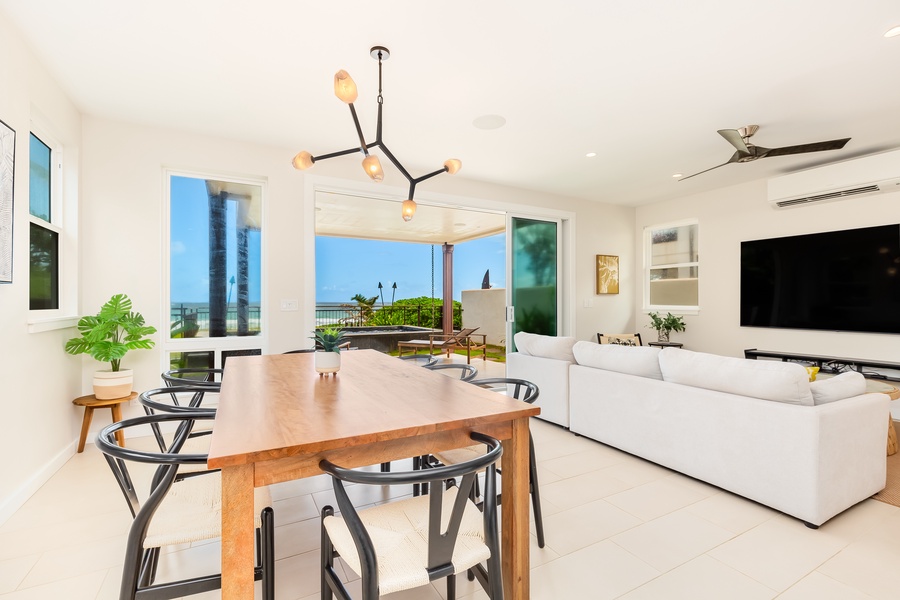 Stylish dining space with an industrial chandelier and direct access to the lanai.