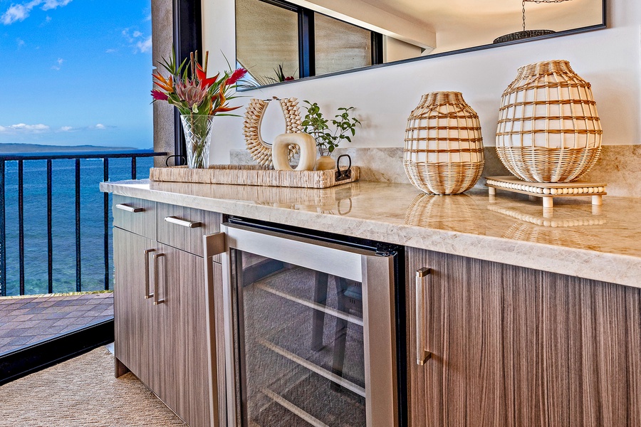 The kitchen includes a wine fridge, making it easy to enjoy a chilled beverage while taking in the ocean views.