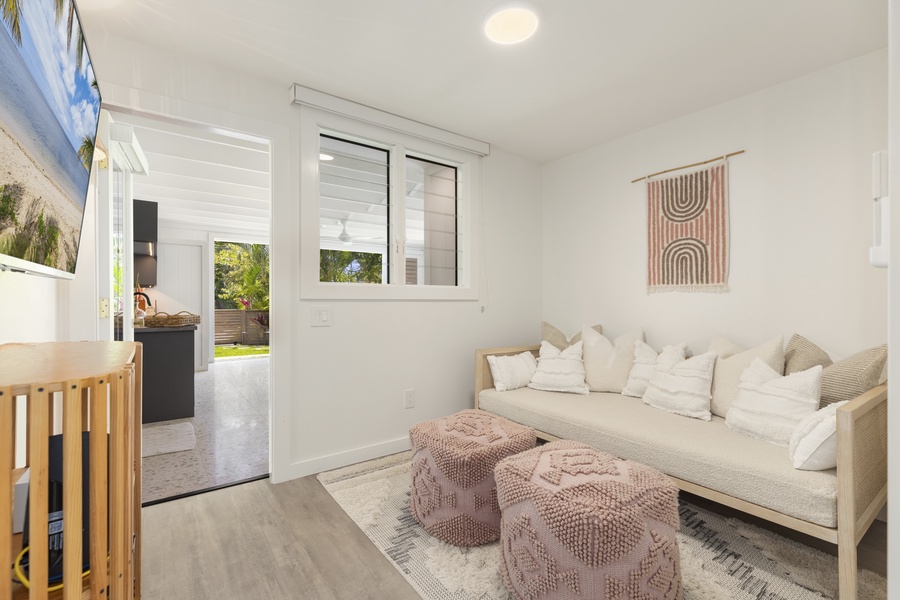 Guest bedroom with seating and opens to patio area