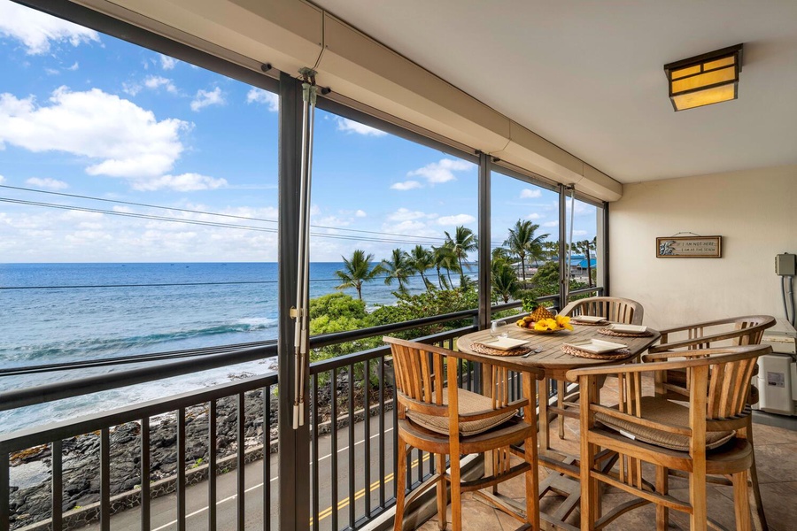 Cozy lanai set up for meals with a view of the Pacific waves.