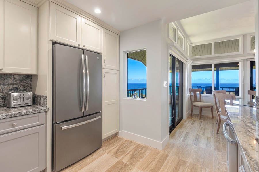 The kitchen not only features high-end stainless-steel appliances but also offers stunning ocean views.