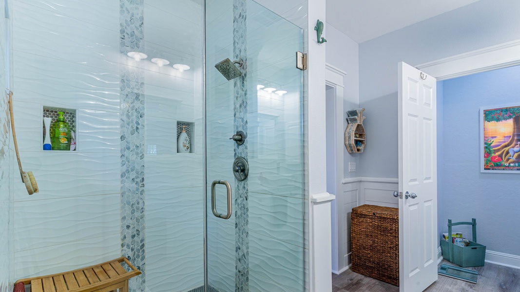 The primary guest bathroom featuring a custom walk-in shower with two shower heads.