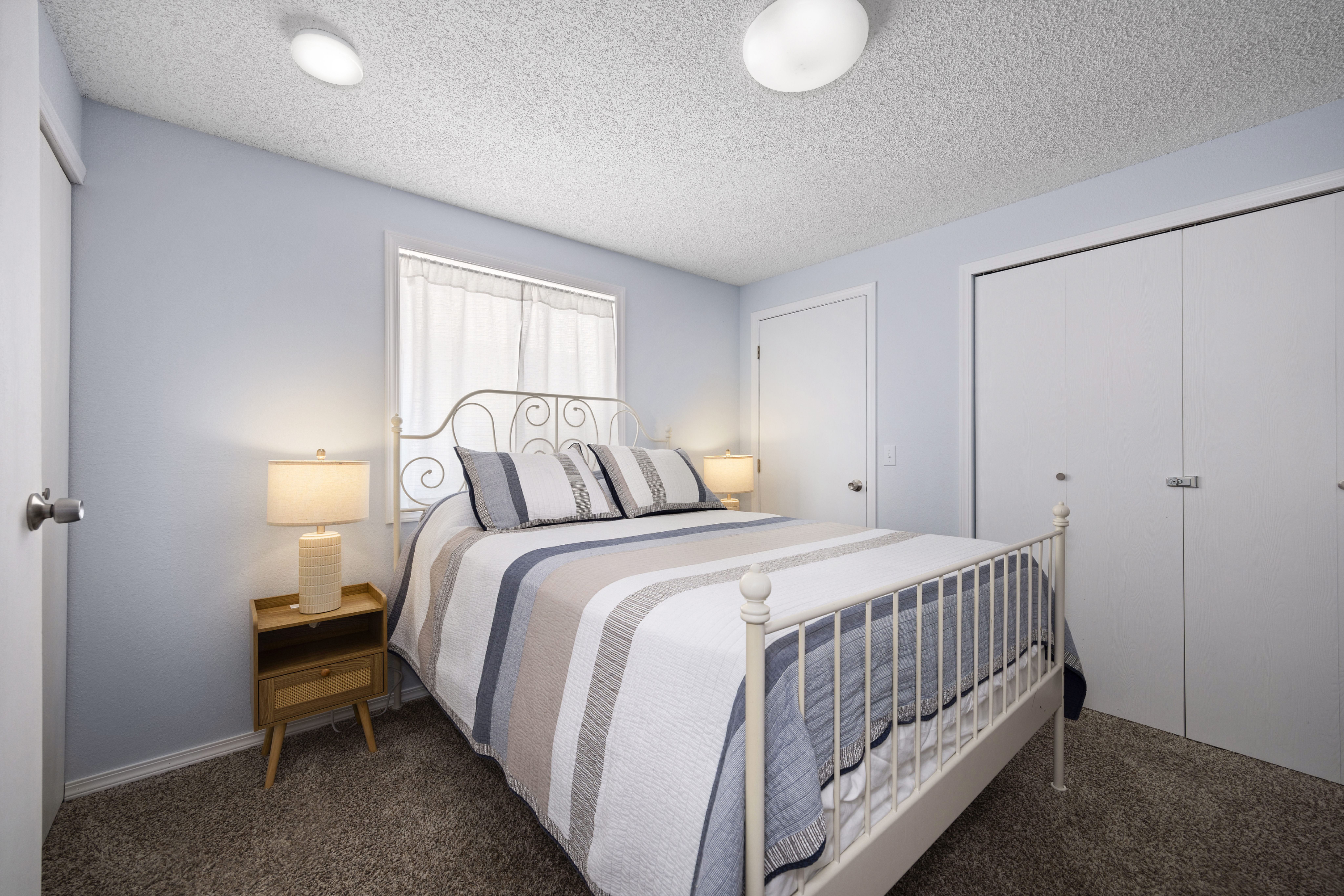 Secondary guest room includes a queen bed—ideal for kids or additional guests.