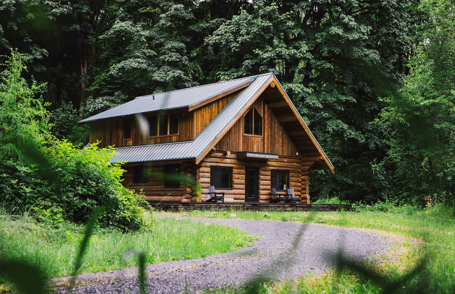 Nestled among towering evergreens, the chalet offers a peaceful retreat near the river.