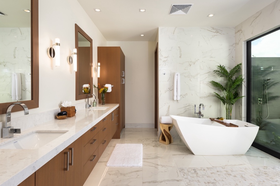 The ensuite features marble, mahogany and natural lighting.