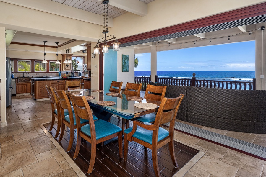 Ocean-view dining setup with adjacent seating—flow from kitchen to lanai is effortless and scenic.