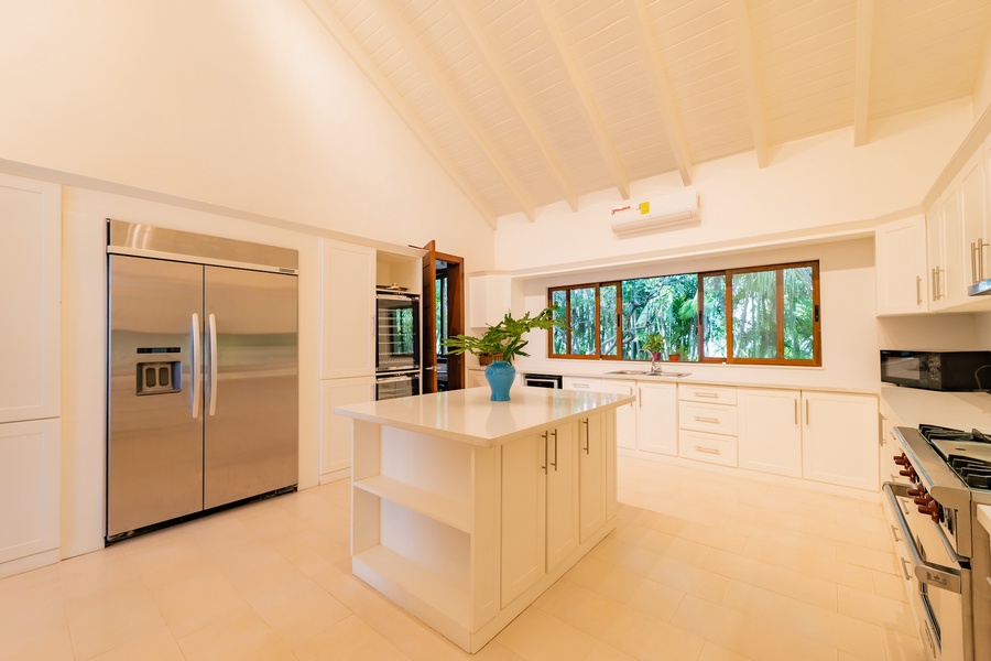 Spacious and bright kitchen with a central island and ample storage, perfect for culinary adventures.