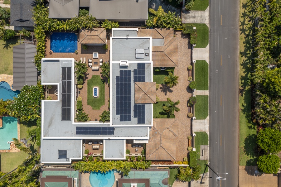 Overhead view showcasing the property’s layout with lush landscaping, outdoor living spaces, and modern design.