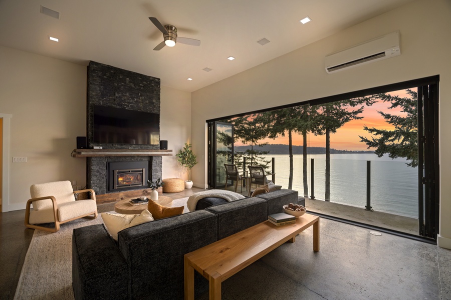 Cozy living area with fireplace glow and sunset view — the perfect setting for evening relaxation.