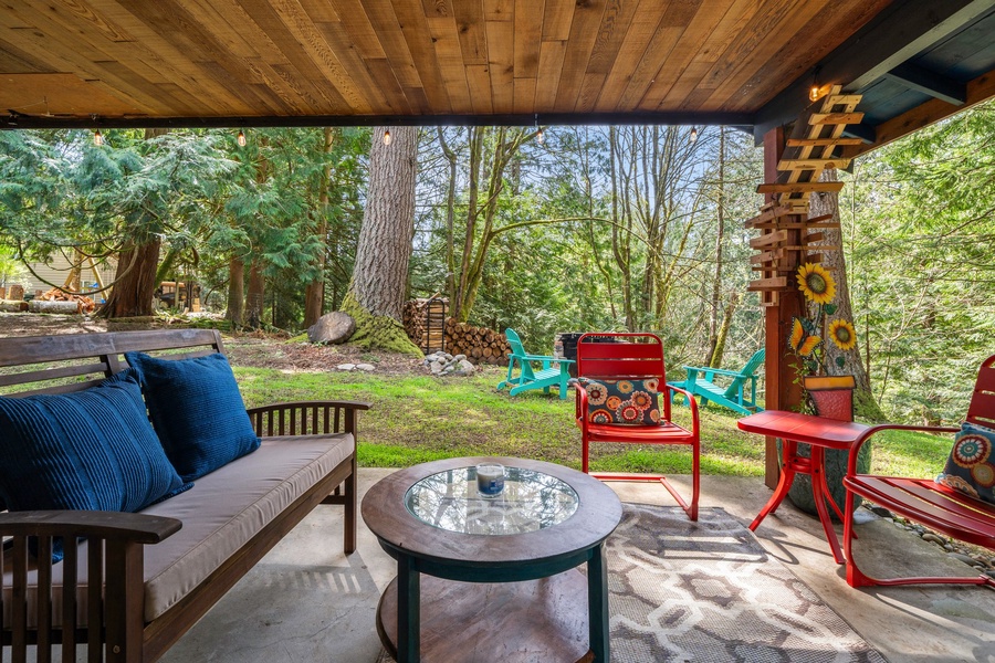 Covered porch with cozy seating is a guest favorite for morning coffee, afternoon reading, or evening wine.