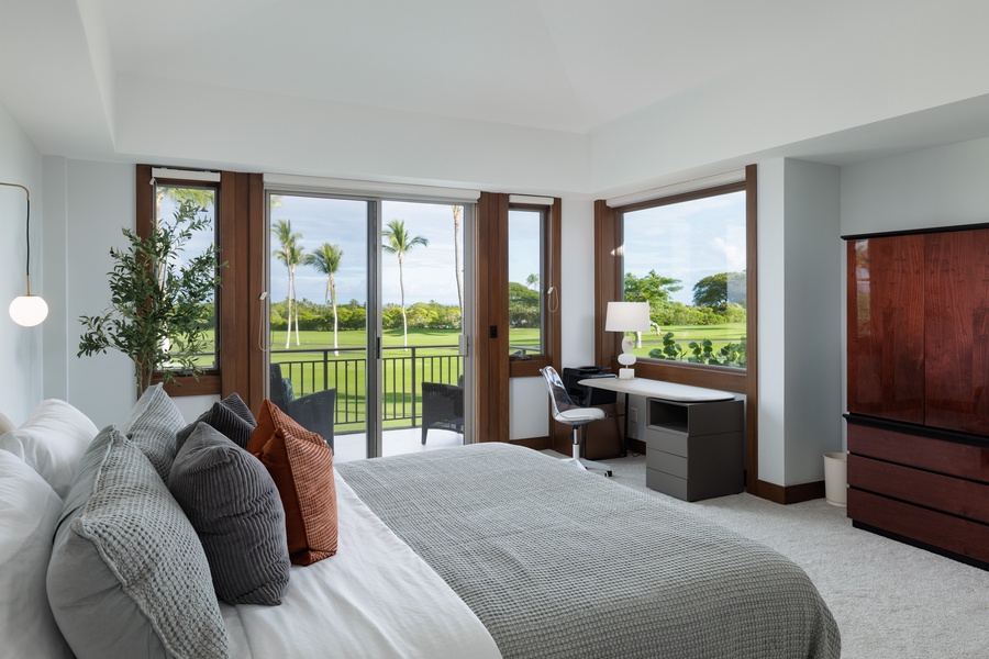 The primary guest suite with a king bed and a dedicated home office with a front seat view of the outdoors.