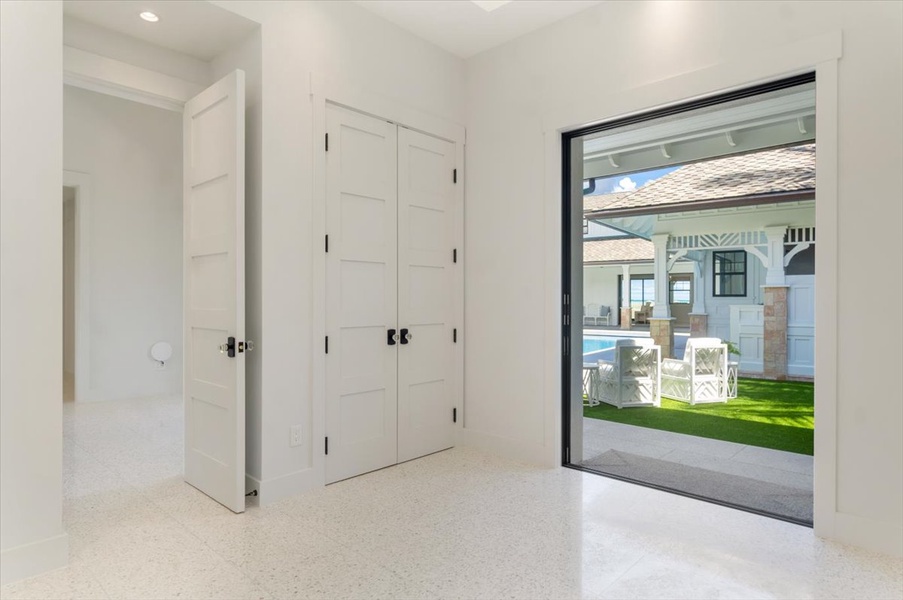 Secondary entryway offering direct access to the poolside and central living areas.