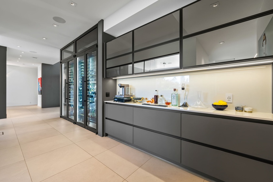 Sleek kitchen with glass-front storage and dedicated prep space.