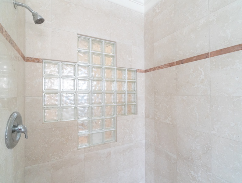Modern elegance of a shower room adorned with glass window blocks