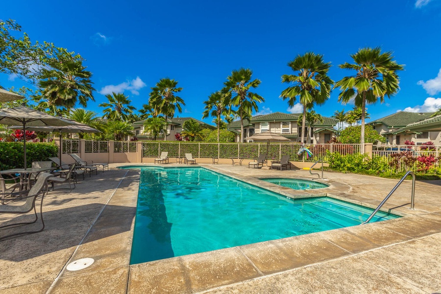 Take a plunge in the community pool with sun loungers by the side.