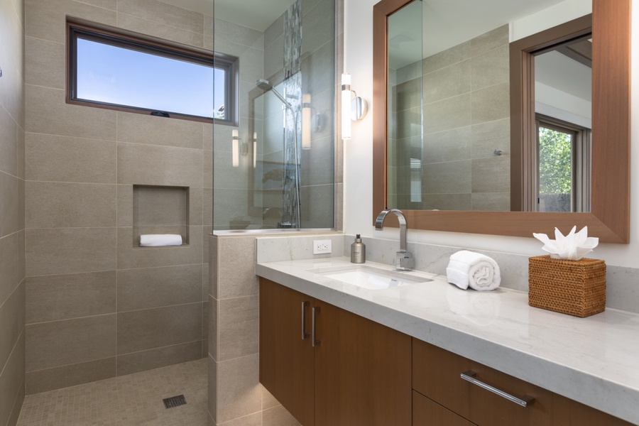 Guest ensuite bathroom with ample vanity space and a separate walk-in shower.