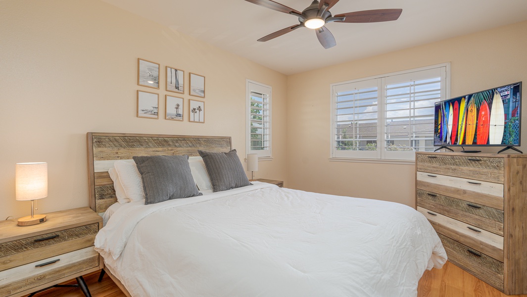 The second guest bedroom has soft linens and tasteful decor.