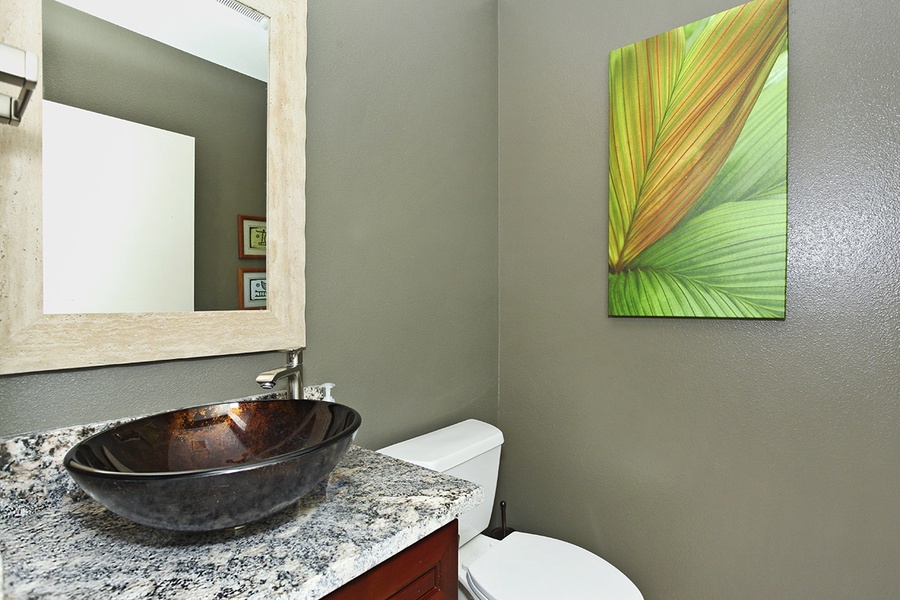 The stunning half bathroom with a designer vanity.