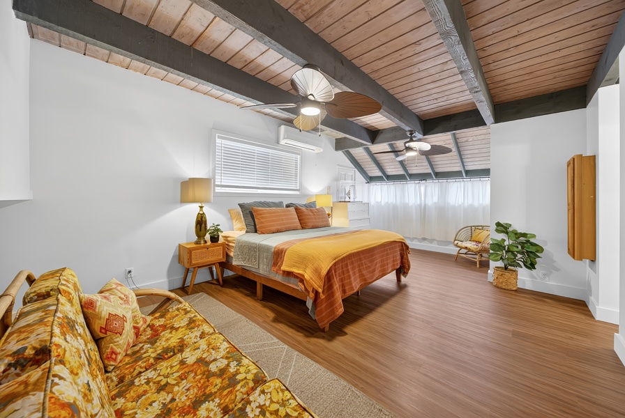 Your spacious retreat features warm wood tones, exposed beams, and a cozy seating area beneath vaulted ceilings—perfect for unwinding after a day of adventure.