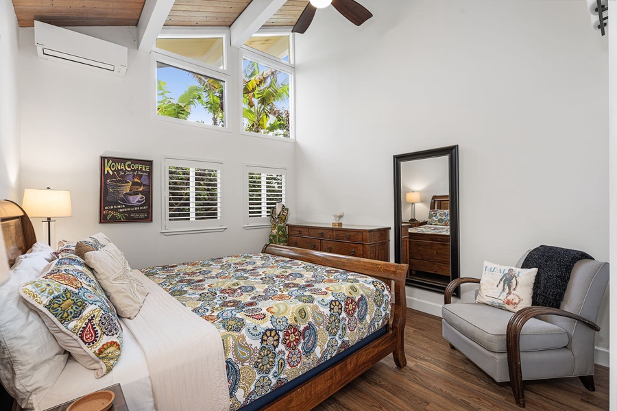 Unwind in a peaceful bedroom, where vaulted ceilings and garden views create a calm retreat.