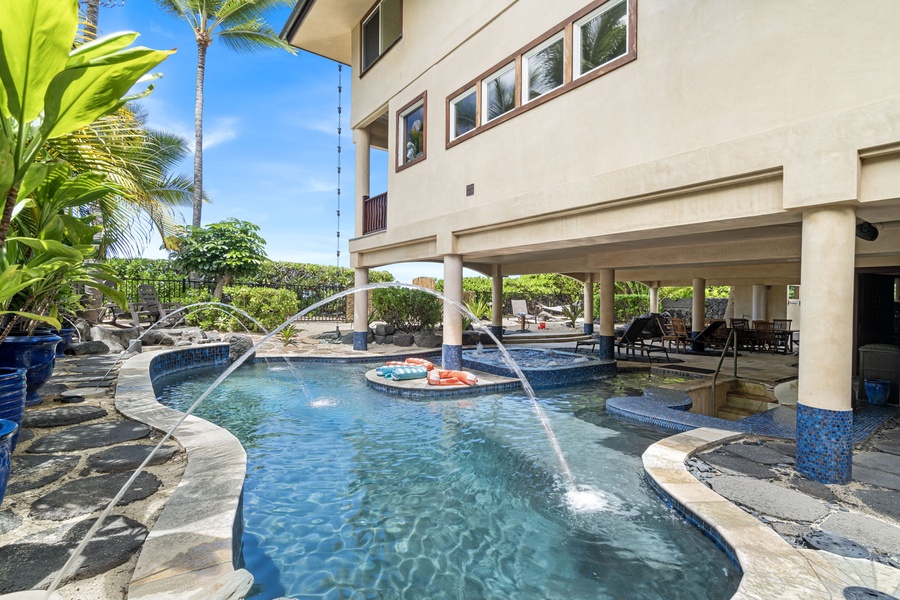 Playful jets and tiki vibes surround this spacious lagoon-style pool—fun for all ages, day or night.