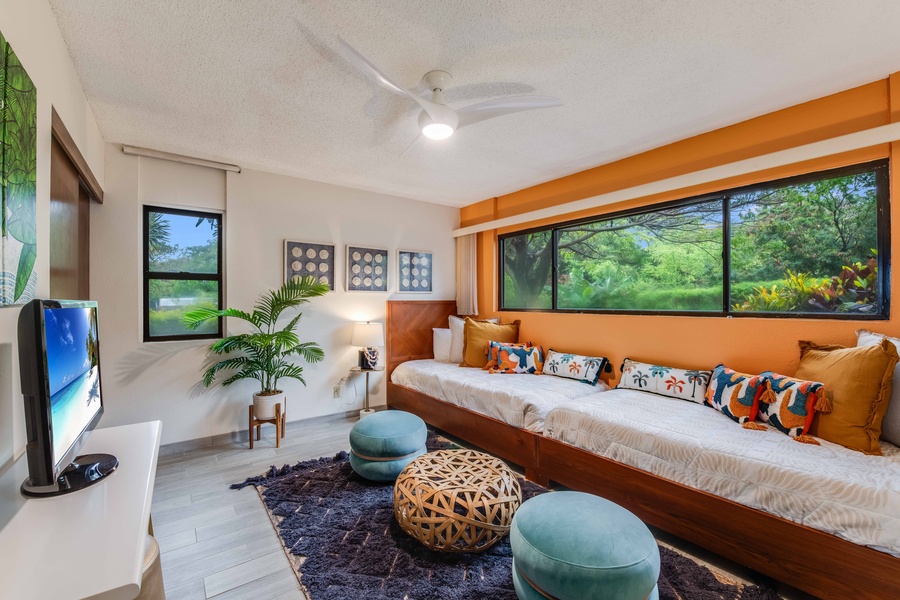 Comfortably accommodate family or friends in the stylish guest room with two twin beds and views of the tropical greenery.