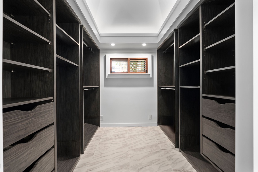Stay organized in style—spacious walk-in closet with custom cabinetry for extended stays at Honolulu Lagoonfront Villa.
