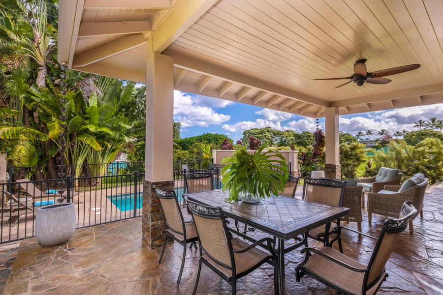 Another shaded dining area at Pohaku Villa with tropical garden and pool views.