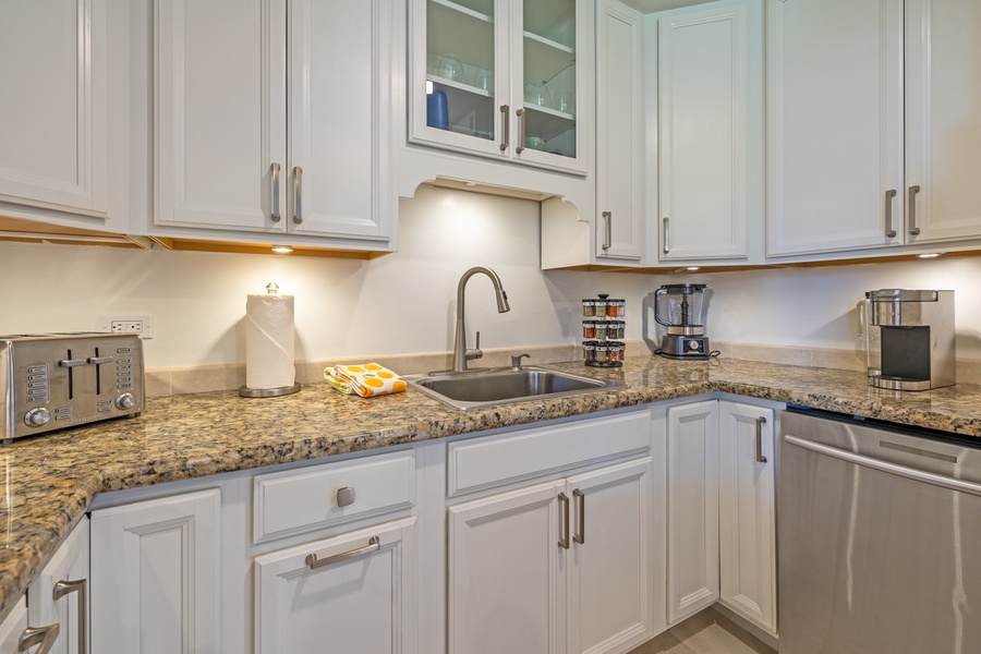 Modern kitchen at Kaanapali Shores 213 with granite counters and ample storage space.