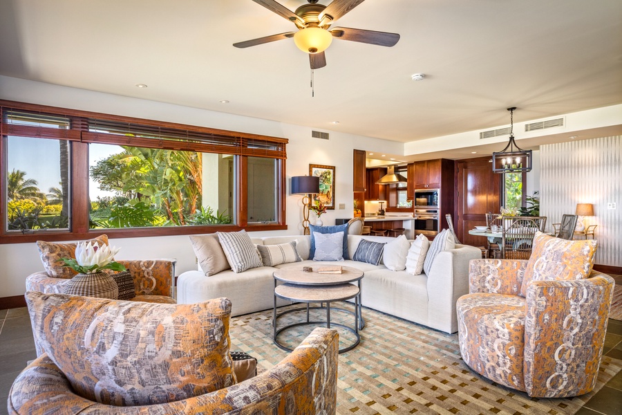 Reverse angle on great room showcasing large picture windows and abundant natural light.