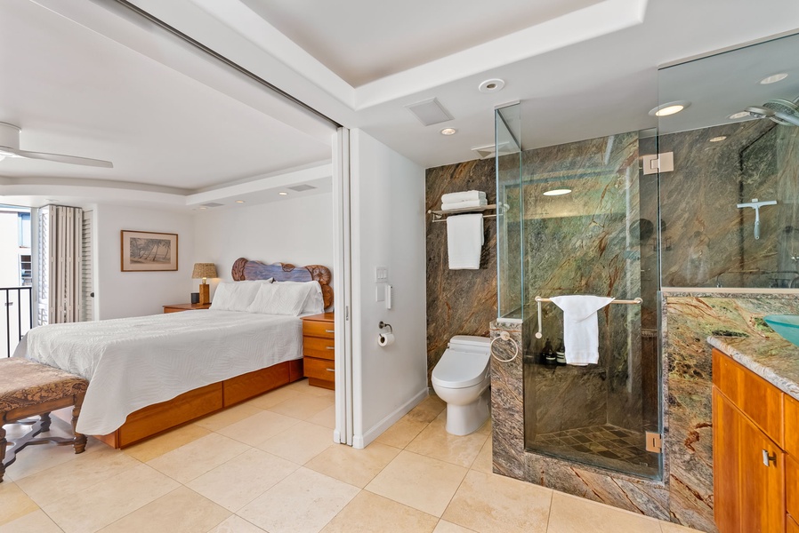 Modern en-suite bathroom with glass shower and upscale finishes, providing a luxurious touch to your stay.
