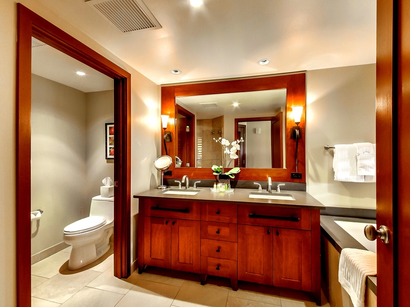 The warm wood accents of the double vanity.