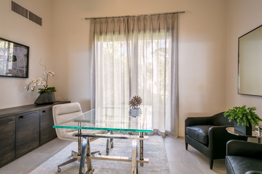 Bright and modern office space featuring minimalist decor and large windows for natural light.
