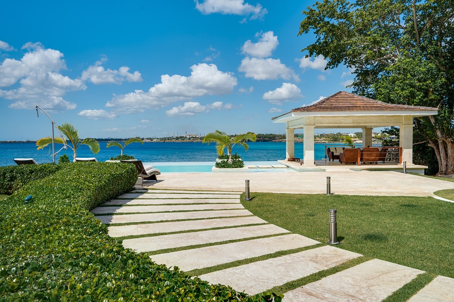Stroll around the yard leading to the pool with ocean views.