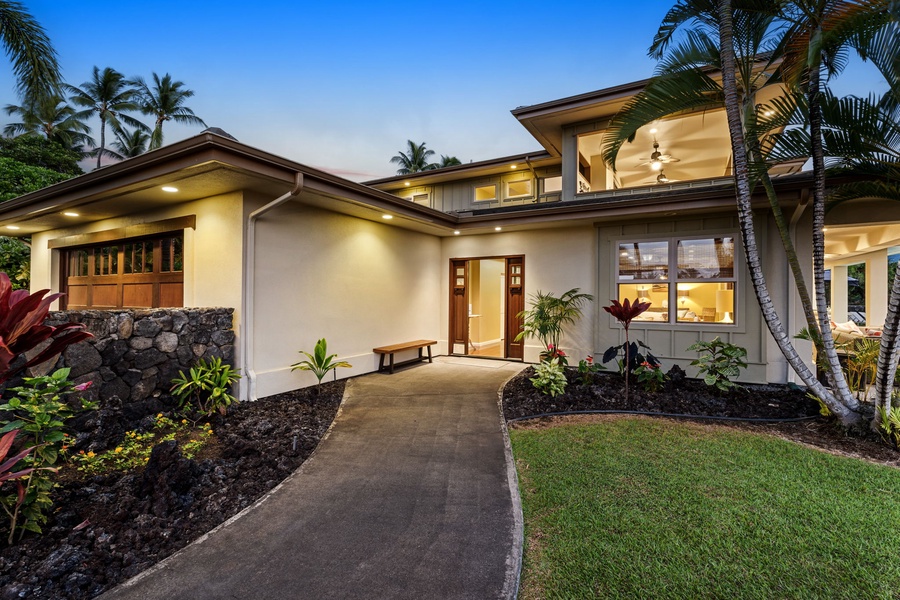 Front view of the residence, showcasing its modern architecture and lush landscaping