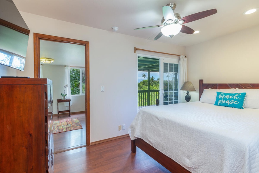 You can access the deck from this bedroom with partial ocean and garden views