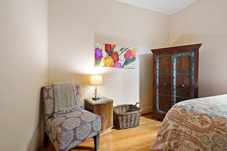 A reading nook with a cozy chair, side table, and artistic decor, perfect for unwinding with a book.