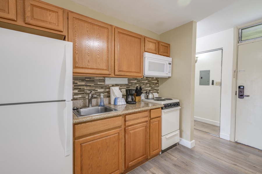 Features warm wood cabinets, granite countertops, and modern appliances—perfect for preparing meals during your stay.