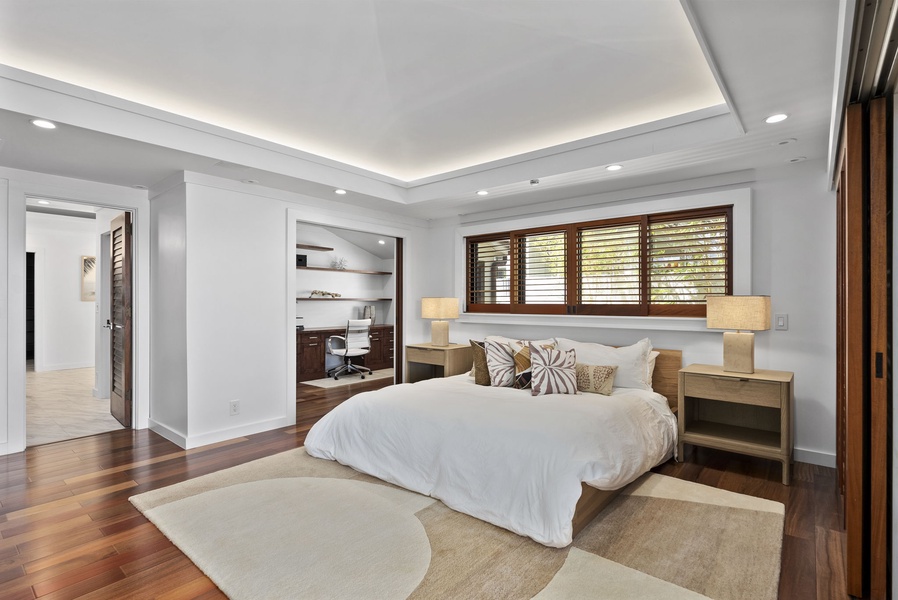The primary suite at Honolulu Lagoonfront Villa features a king bed, luxe finishes, and direct lanai access with ocean views.