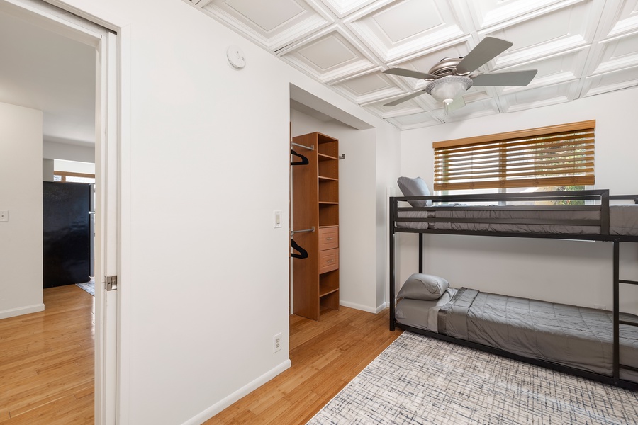 This bonus bedroom includes a sleek bunk setup and vaulted ceiling—great for kids, teens, or extra sleeping flexibility.