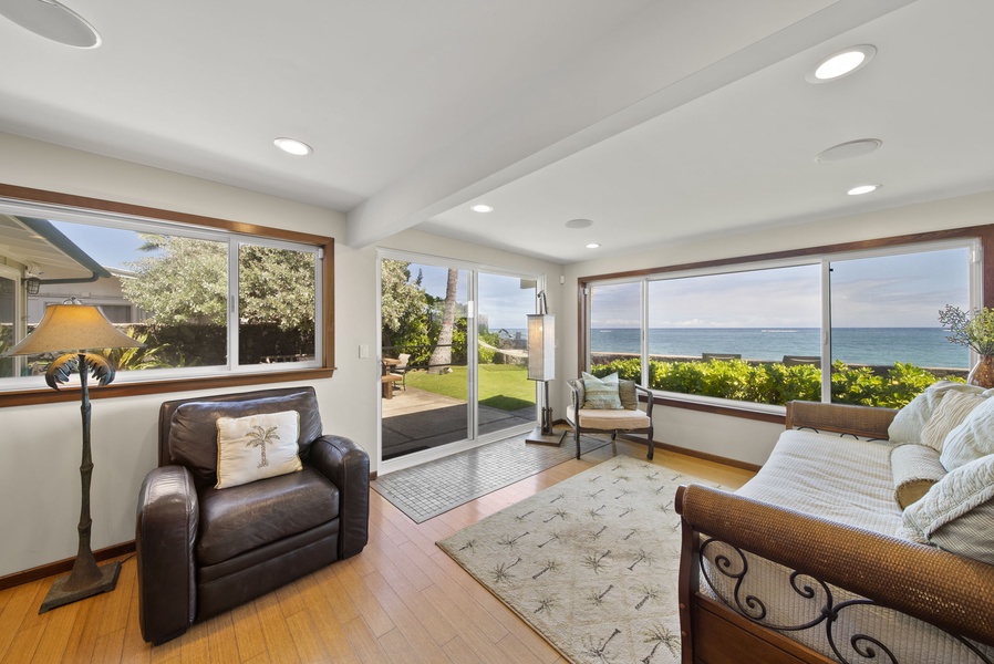 The oceanfront room, leading out to the lanai, has a plush armchair and daybed