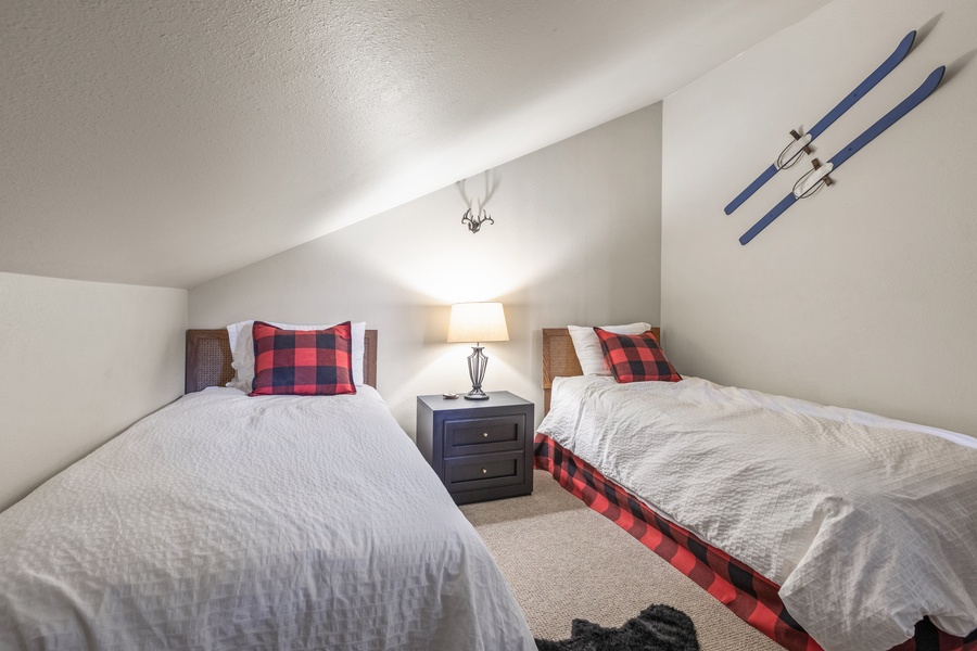 Comfort awaits in Guest Suite 2 featuring two cozy twin beds, perfect for friends or siblings sharing stories before a restful night's sleep.