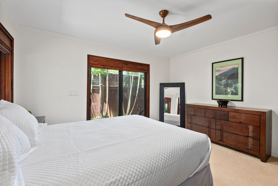 The bedroom offers a ceiling fan, dresser and large closet.