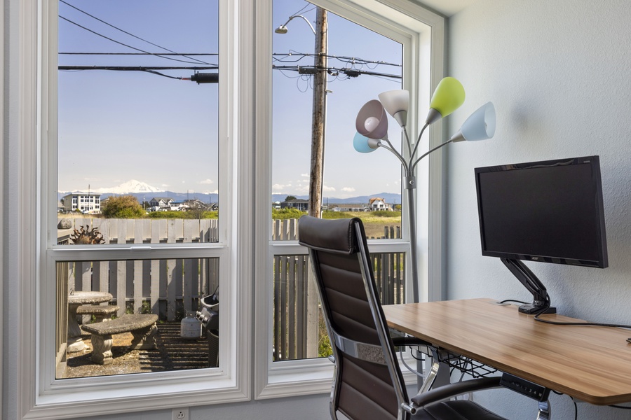 Work remotely with an inspiring view—this dedicated desk space overlooks the serene shoreline.
