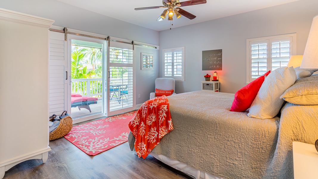 The primary guest bedroom with bright accents and access to the lanai.