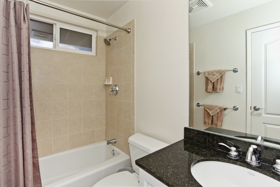 The second guest bathroom with a bathtub and shower.