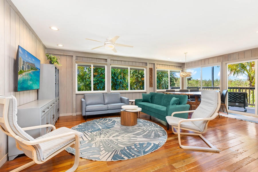 The main living room welcomes you with natural light, open windows, and coastal comfort.